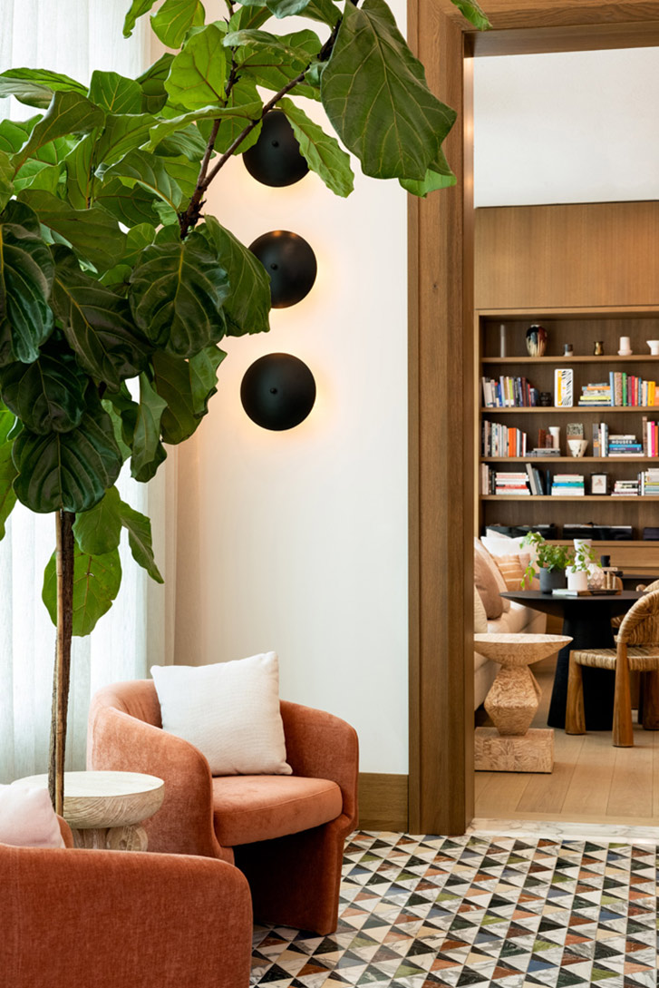 Interior of Design Studio showing office with books and rose velvet chairs
