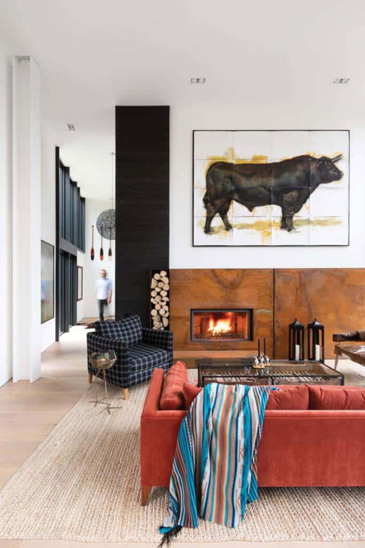The homeowners repurposed some items from their previous cabin, adding a cozy Canadiana cabin feel to the modern space: a bearskin rug, a collection of heavy blankets and colourful oars.
