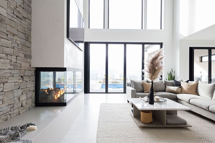 Open Living Room With Glass Walls and Fireplace