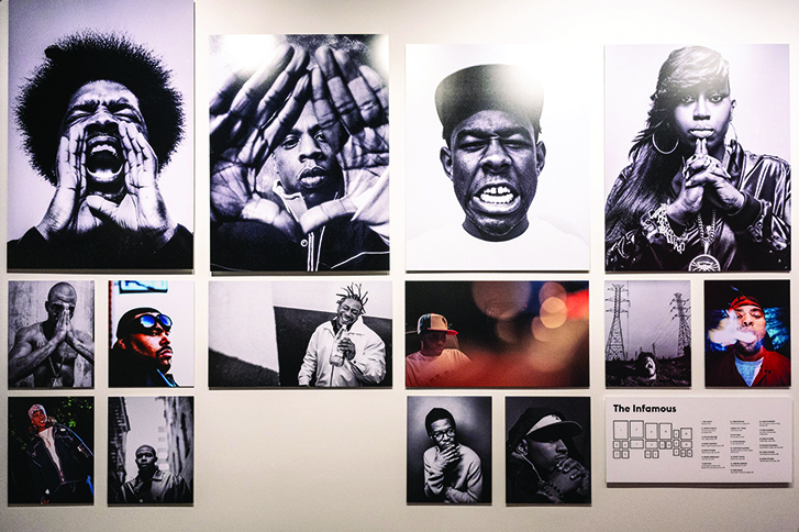 Black and White Photograph Exhibit on white wall of hip hop artist portraits 