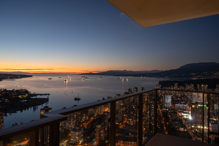 A sunset view from off a balcony facing English Bay