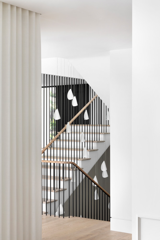 black stairwell with bocci light fixture