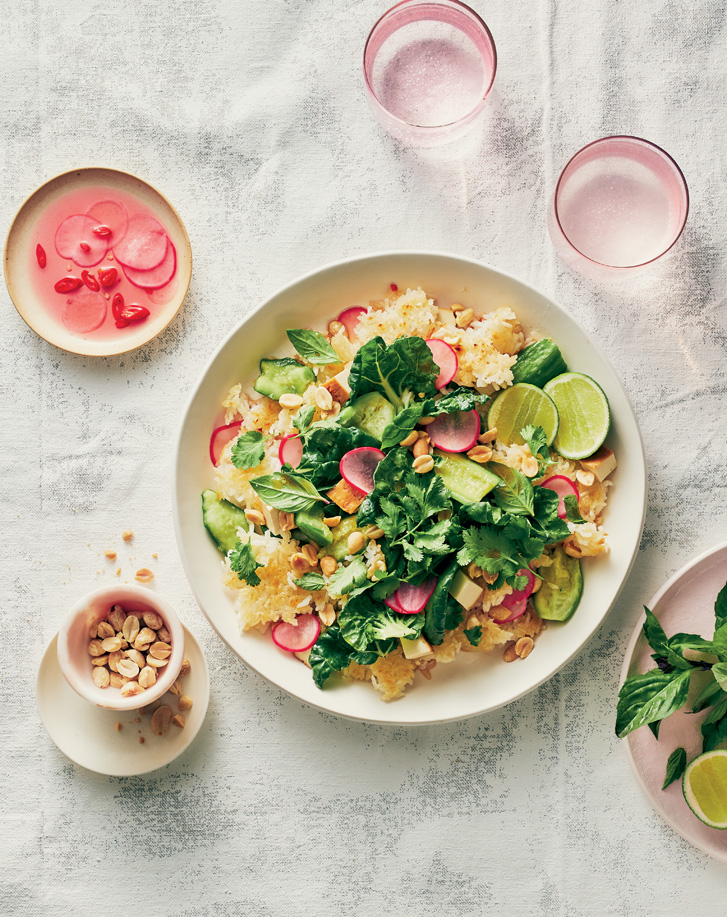 a colourful rice salad in bowl with pickled radishes on the side