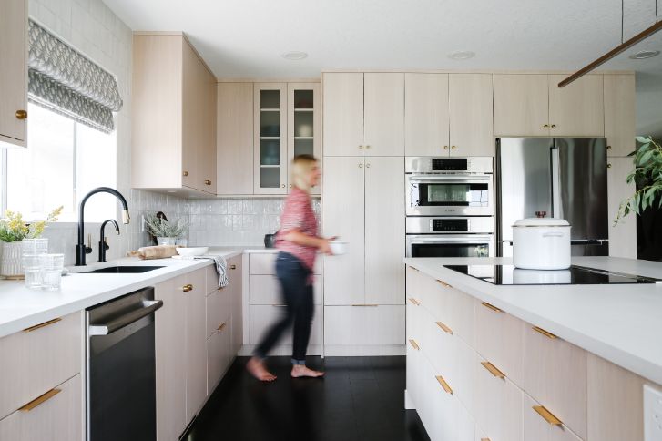 a blurred woman in a bright beautiful kitchen