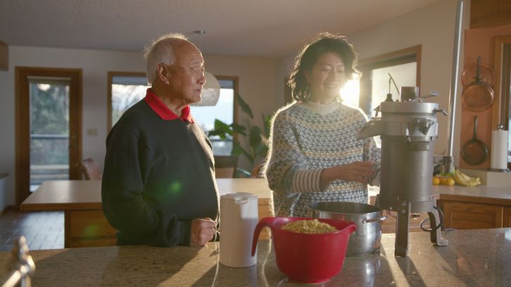 jackie making food with an elderly chinese man