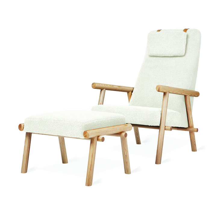 A white cushioned oak chair with foot stool.
