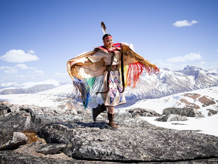 indigenous woman in the mountains, wearing manitobah mukluks