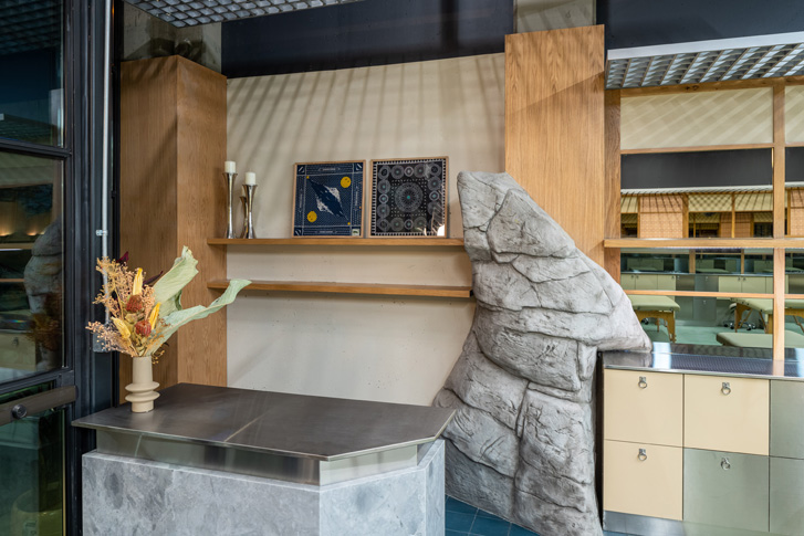 Front desk with stone art piece built into wall