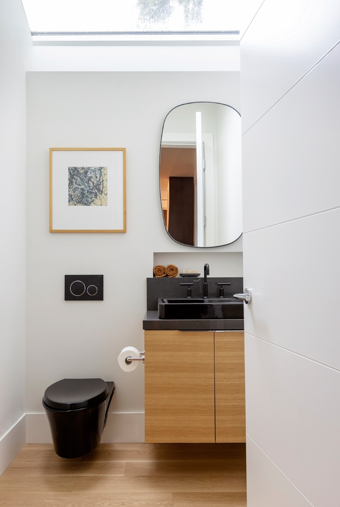 designlab interiors vancouver multi-generational home bathroom with black sink and mirror