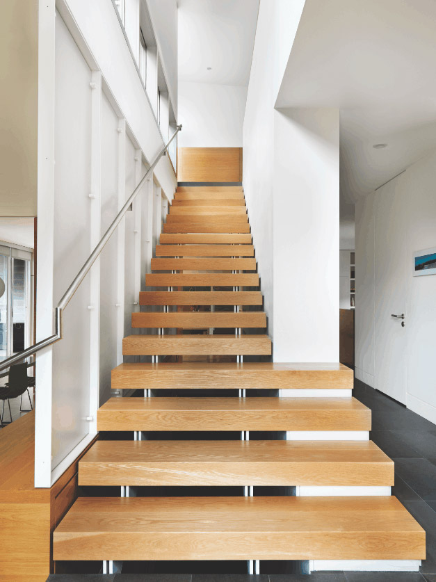 STAIRCASE: Floating white oak risers make up the central staircase, which is supported by a white powder-coated steel frame.