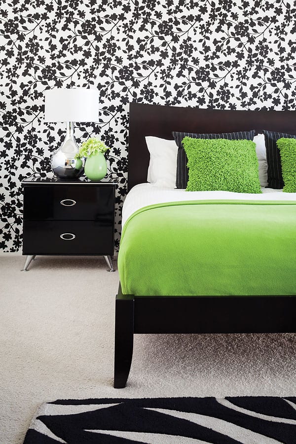 Inside the master bedroom the vibe is more playful with a blast of lime green paired with a baroque bold wallpaper.