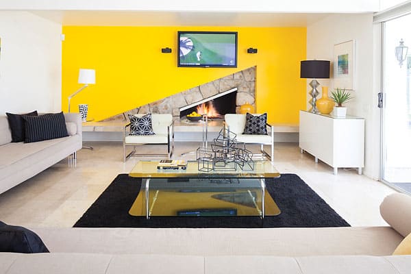 Colour Field | While the house dates from the heyday of mid-century design you won't find a parade of the usual design suspects—no Eames, no Saarinen. Instead the howeowners opted for the more opulent look of Hollywood Regency. The style’s hallmarks—bold colours and strong patterns— are on display in the yellow-walled living room (bottom), and a yellow spare bedroom (top-right). The kitchen (top-left) goes full modern with Starck’s Ghost chairs.