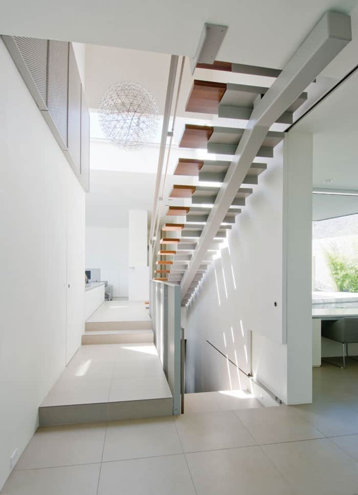 This home’s staircases bring a lightness to the home that keeps the vibe airy and open. Photo by Matt McLeod. 