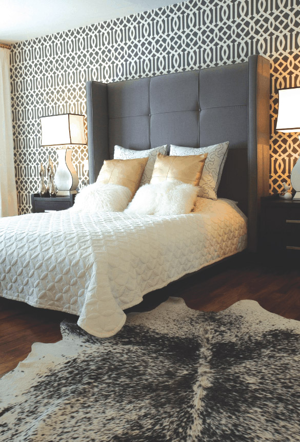 MASTER BEDROOM: “Imperial Trellis,” a Kelly Wearstler-designed wallpaper, provides a playful backdrop to an oversize, charcoal bed from Silva outfitted with linens from 18Karat.