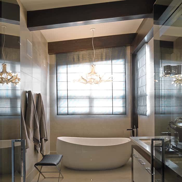 The resin antler fixture above the bath is a modern update of classic Rocky Mountain design
