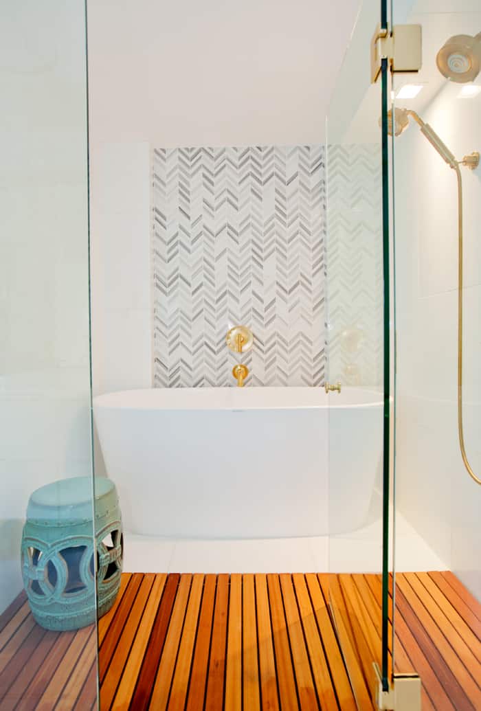 For the feature wall in the bathroom, she selected an angular chevron pattern that contrasts the oval freestanding tub. 