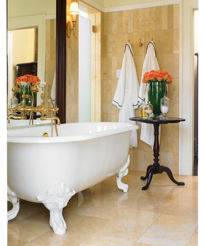 Use an oversize mirror behind the bath Brown had the faucet installed—very carefully—through this elegant mirror that she’d purchased in L.A., emphasizing the bath as a focal point to the room.