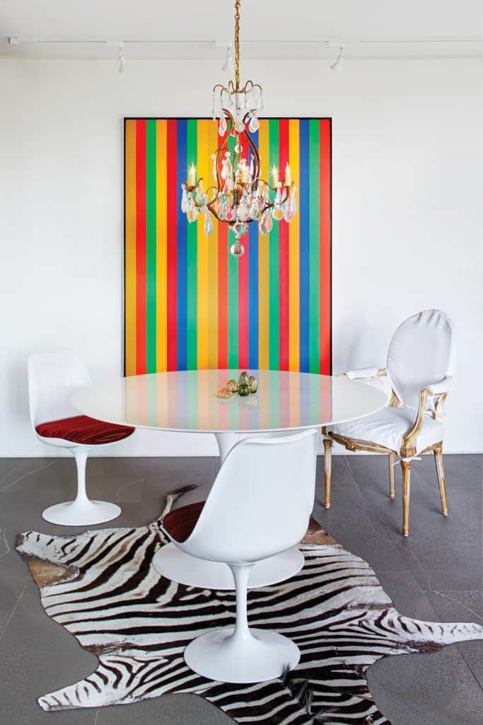 A colourful Guido Molinari painting adds vibrancy to a stark white dining nook.