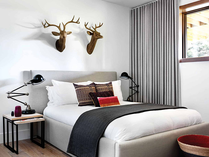 A plain white wall is transformed with rustic wooden deer. 