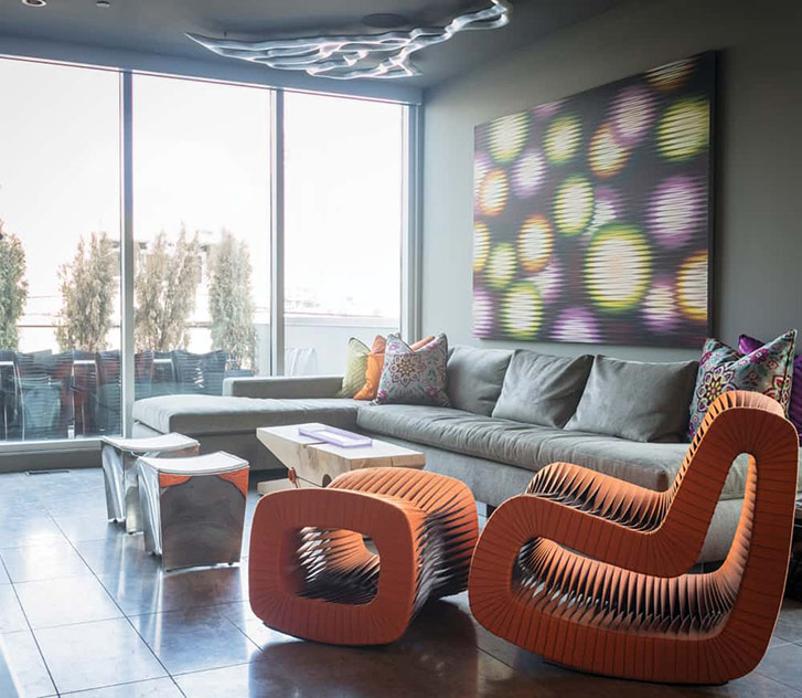 A chair made of seatbelts adds a pop of colour to this space—a Mitchell signature. Photo by Chris Sattlegger.