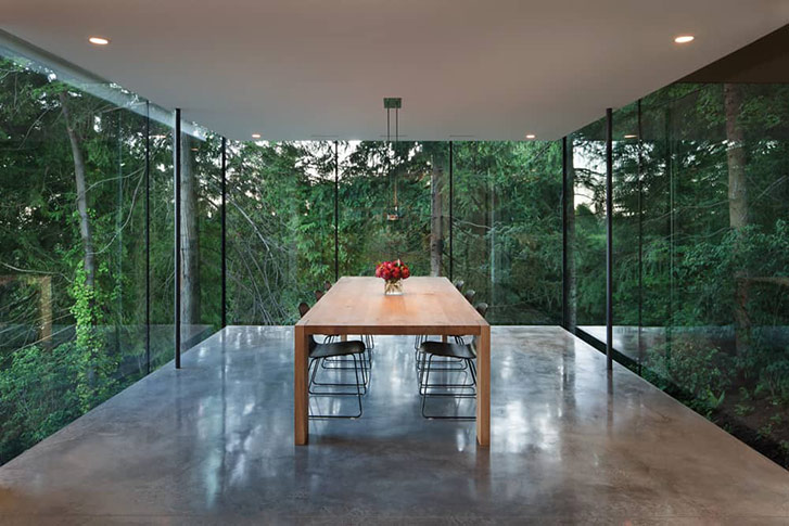 Designer Nigel Parish created more floor space by cantilevering a portion of the main and upper floors, as well as the dining room, which extends 15 feet past the foundation. Photo by Ivan Hunter.