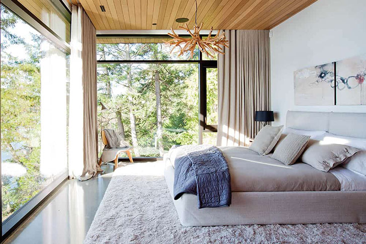 In this Gulf Island home designed by Carrie McCarthy of Carrie McCarthy Studio and Tanja Hinder of Marrimor, the natural, earthy palette of linens and woods is anything but dull thanks to the pair’s thoughtful use of texture throughout the space. Ripple-fold linen drapes line the walls, creating a cocoon-like effect at night; on the bed, a linen duvet pairs with a knit throw cushion and silky throw at the foot; and even the bed itself offers visual texture, with its warp and weft linen coverlet. And the pièce de résistance: that lush wool area rug, a cozy place to step each morning. (Photo: Janis Nicolay.)