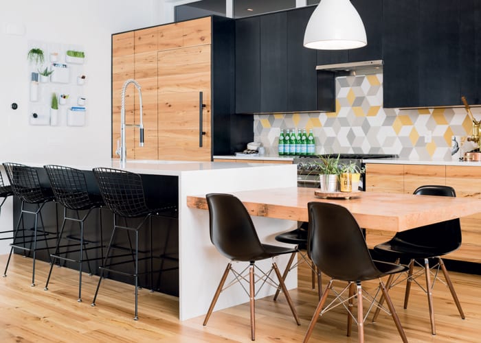 Designer Majida Boga Devani paired black cabinetry and chairs with fun geometric tiles and reclaimed wood accents in her own Calgary kitchen (Photo: Jared Sych)