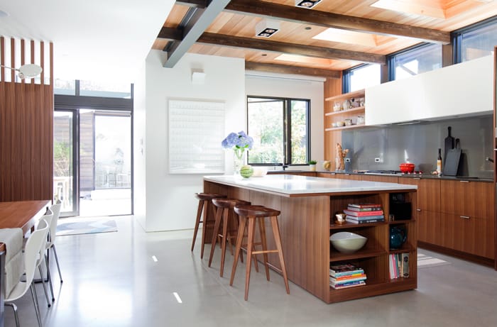 Because the kitchen island is the first thing you see as you climb the stairs to the second floor, Ashmore had the visible underside of the counter lined with walnut, rather than leaving it raw.