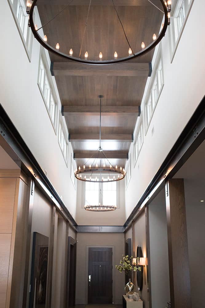 By adding wooden columns and steel I-beams to the double-storey entranceway, designer Nam Dang-Mitchell created both a warmer, more welcoming space and brought a Napa-style vibe to the Calgary home.