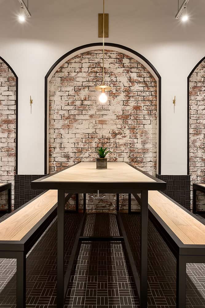 Classic brick arches, combined with clean lined custom furniture creates a seamless blend of old and new.