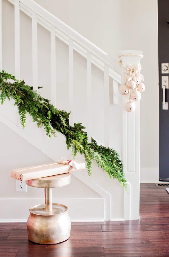 Garland can go at the bottom of your banister, like Falken Reynolds has done here. It gives a holiday look, without compromising functionality. (Photo: Janis Nicolay.)