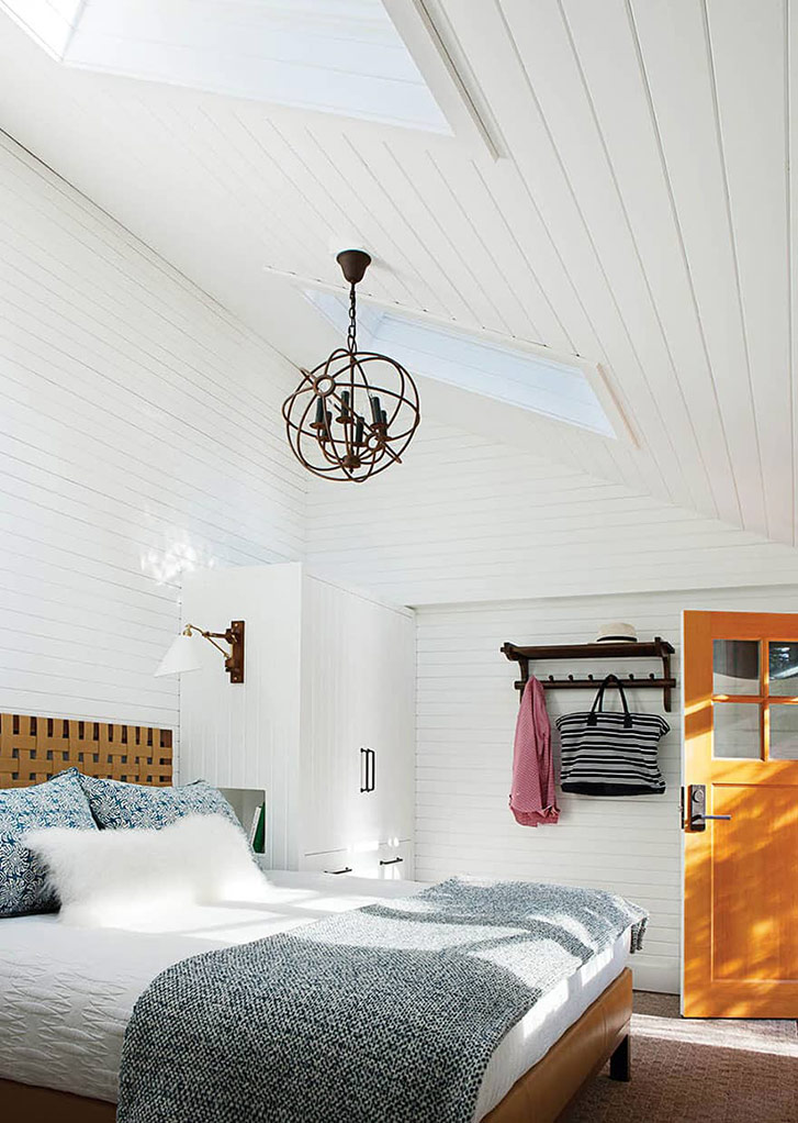 Well light, white bedroom with skylight.