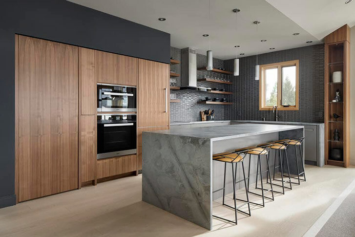 Recessed refridgerator, oven, microwave and pantry cabinet inside a home's updated kitchen