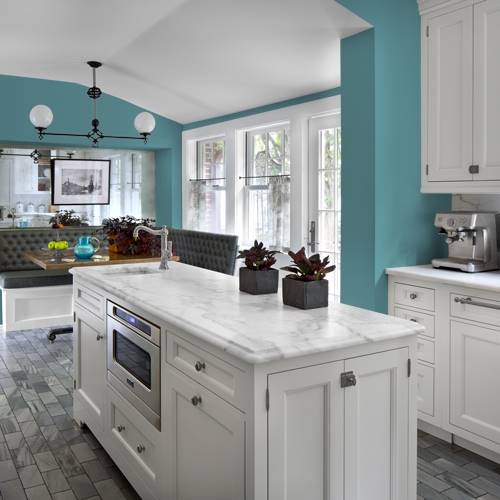 a kitchen painted in a cheery teal hue